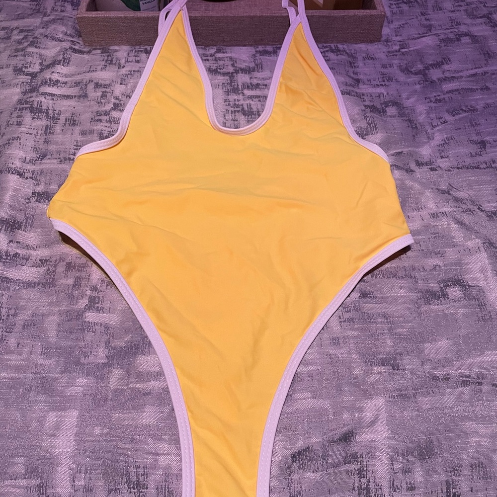 Yellow, trimmed in white thong one piece swimsuit